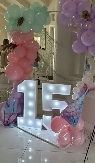 Mint, pink and lavender balloon garland with light-up 15 marquee numbers and a mermaid tail